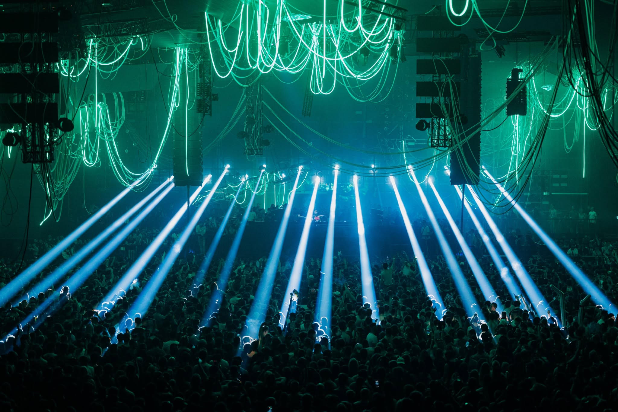 Arena show lit in neon with PK Sound line arrays